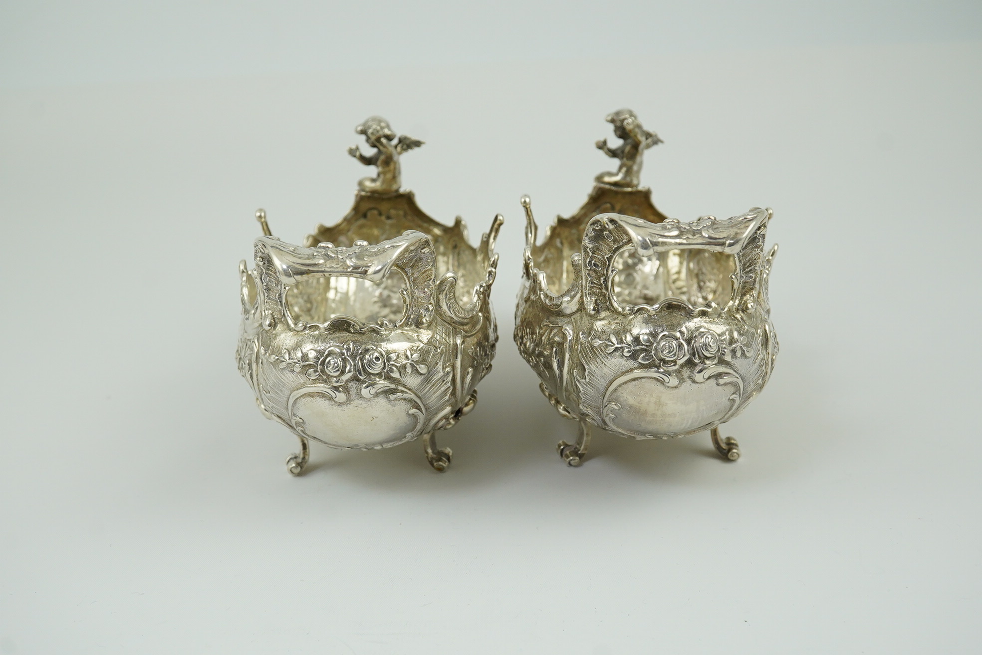 A pair of late 19th century German Hanau ornate embossed silver oval sweetmeat bowls